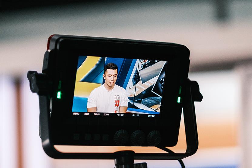 A picture of the camera view finder as it focuses on Shawn Rashid taking part in a television interview